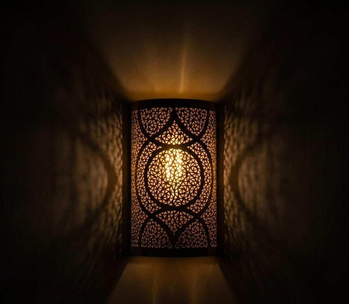 Handmade Moroccan Brass Cylinder Wall Sconce – Pierced Geometric Wall Light with Circular Arabesque Pattern, Warm Golden Glow and Dramatic Shadow Projection