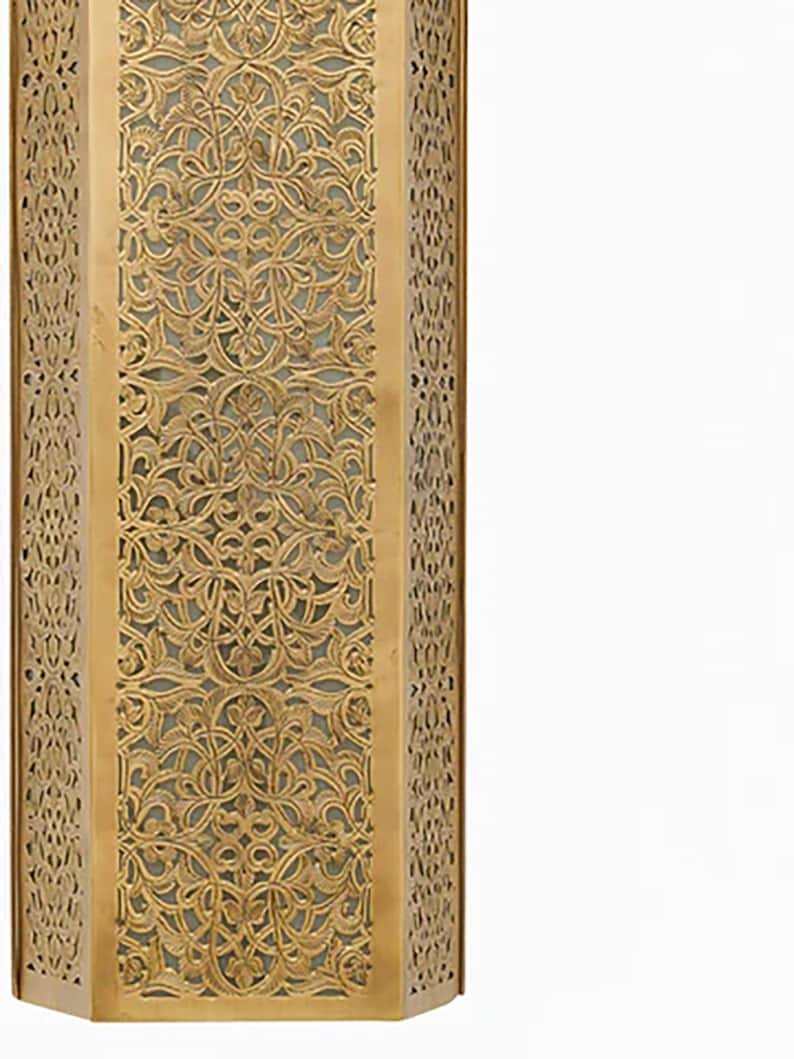 This stylish, shaded contemporary Moroccan wall light adds a touch of elegance and sophistication to any home decor. This stylish, shaded contemporary Moroccan wall light adds a touch of elegance and sophistication to any home decor.
