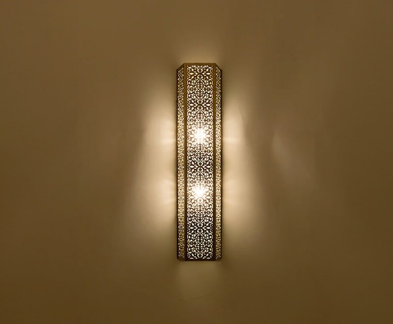 This stylish, shaded contemporary Moroccan wall light adds a touch of elegance and sophistication to any home decor. This stylish, shaded contemporary Moroccan wall light adds a touch of elegance and sophistication to any home decor.